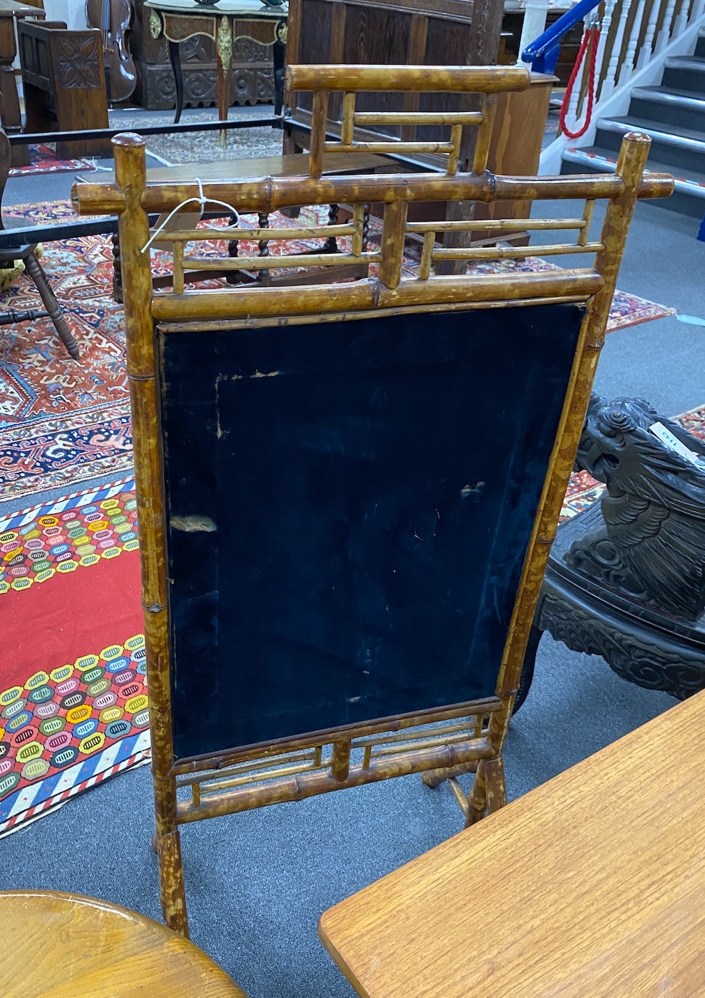 A Victorian bamboo firescreen with inset silk peacock banner, width 55cm, height 113cm
